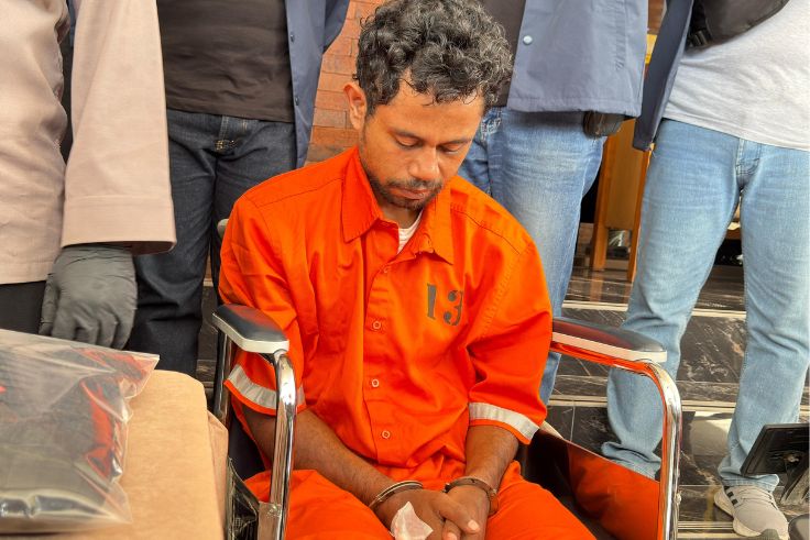 Viktorius Ariano Pukul (25) tertuntuk lemas diatas kursi roda saat dihadirkan di Mapolresta Denpasar, Senin (19/05)