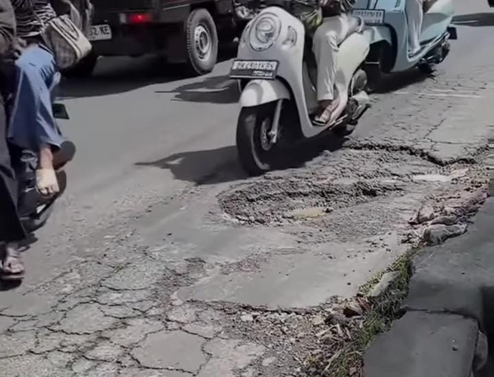 Pengendara melintas di jalan rusak di wilayah Desa Sayan, Kecamatan Ubud pada April 2025 lalu.