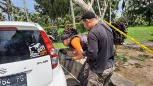 Kaca mobil Suzuki Splash yang parkir di pinggir jalan mengalami kaca pecah.