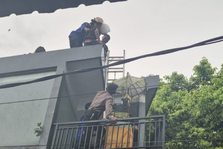 Petugas mengevekuasi R yang nyaris lompat dari lantai 2.