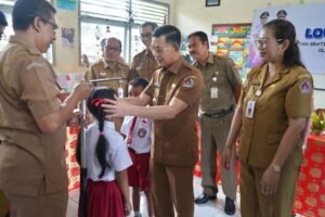 Bupati Klungkung I Made Satria memeriksa kesehatan siswa saat peluncuran Program Cek Kesehatan Gratis di SD Negeri 2 Bakas, Banjarangkan, Senin (11/8/2025).
