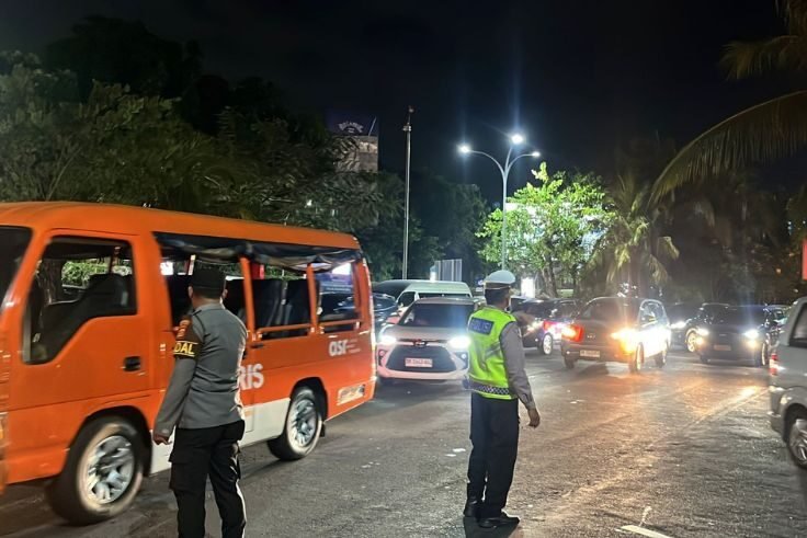 Personel Polres Kawasan Bandara I Gusti Ngurah Rai bersama instansi terkait mengatur arus lalu lintas saat listrik padam di area bandara, Jumat (10/10/2025) malam.