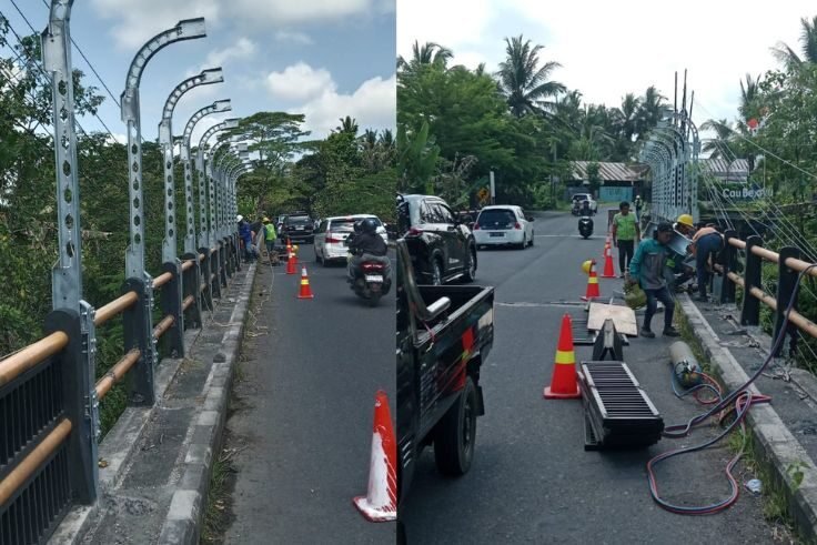 Petugas tengah memasang railing pengaman di Jembatan Cau Belayu, Tabanan,