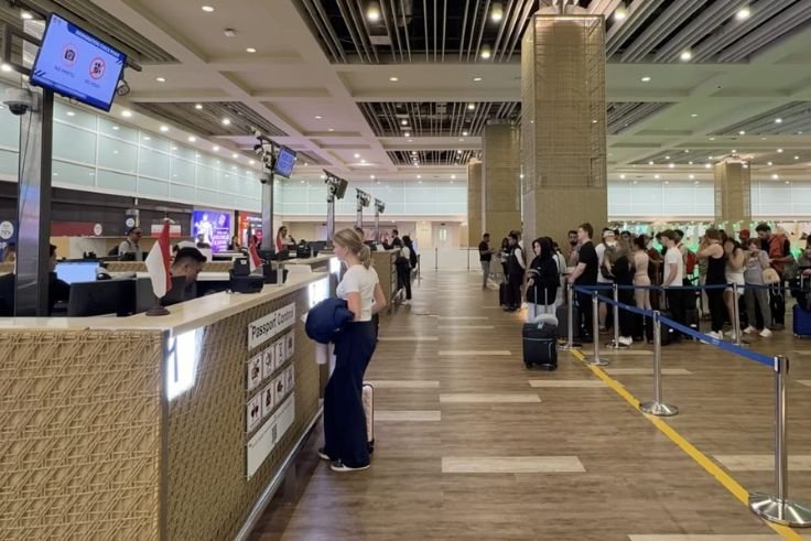 Petugas Imigrasi Ngurah Rai melakukan pemeriksaan dokumen penumpang internasional.