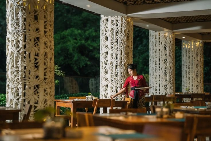 Sungai Restaurant offers a scenic riverside dining experience overlooking the lush Wos River valley in Ubud, Bali.