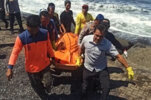 Petugas gabungan mengevakuasi jenazah seorang pria yang ditemukan meninggal dunia di sela-sela batu pemecah ombak Pantai Purnama.